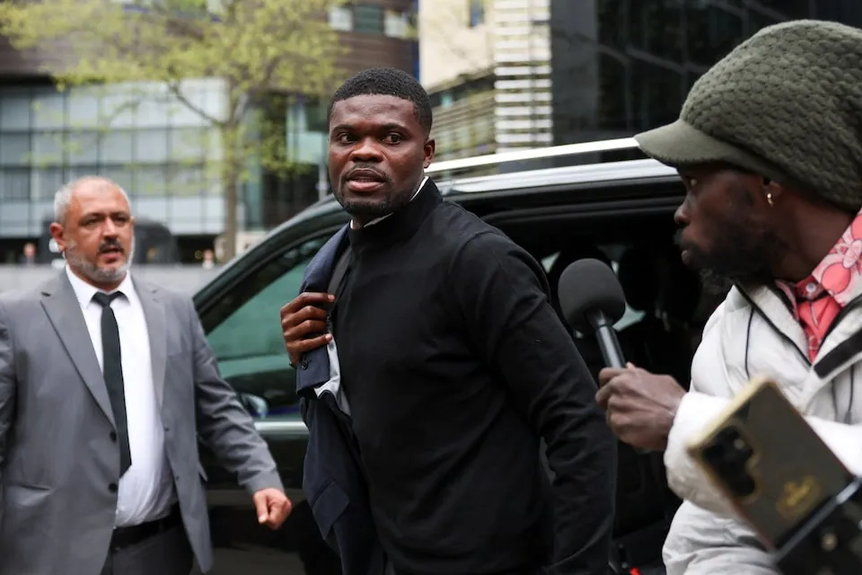 Ghana national team and Villarreal midfielder Thomas Partey, who is facing two additional counts of rape and has pleaded not guilty to five counts of rape and one count of sexual assault, walks outside Southwark Crown Court in London, Britain, April 13, 2026. REUTERS/Hannah McKay